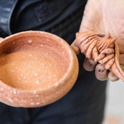 A ceramic bowl and a ceramic fiddler crab.