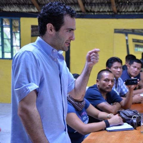 A man speaks to a group of oil workers