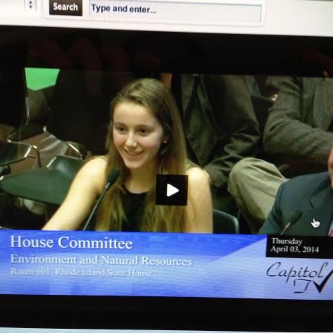 A young woman testifies before a legislative committee