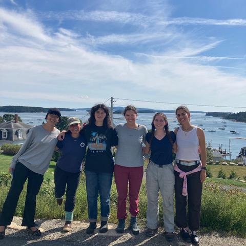 A group of students standing in front of the ocean