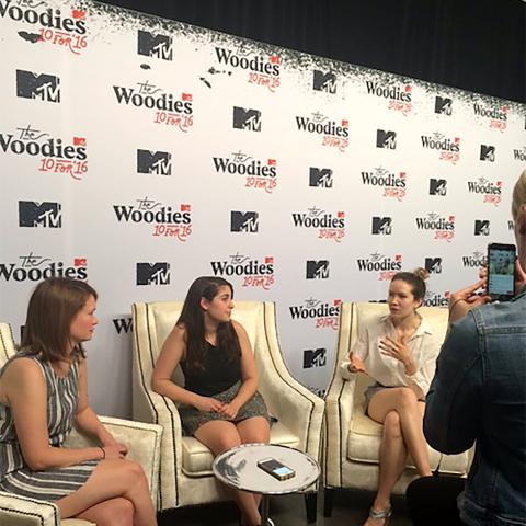 A group of women sitting in chairs and talking