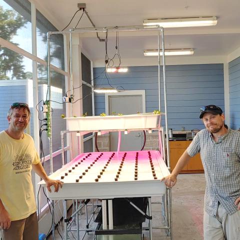 Two men in an aquaponics lab