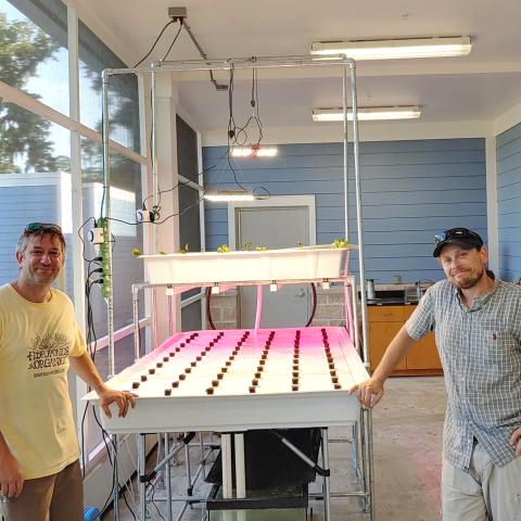 Two men in an aquaponics lab