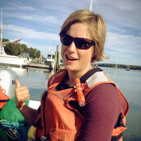 A woman joking while on a ship