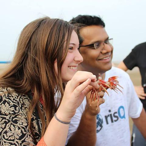 A woman holds a crab