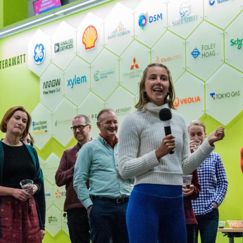 A woman speaks to a group of people