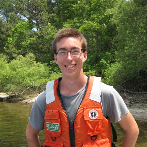 A man in an orange vest