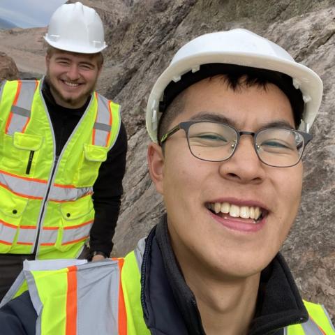 Two young men wear hardhats