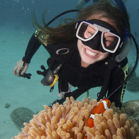 A young woman SCUBA diving