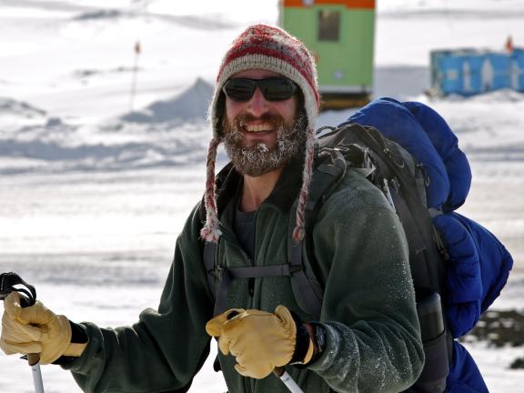 A man in a snow-covered landscape smiling