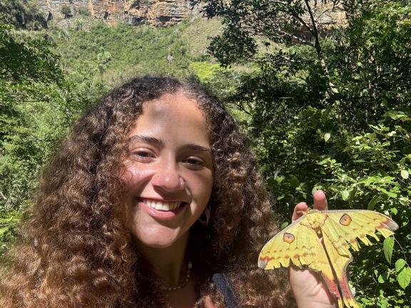 Raquel Reis stands with a moth in Isalo National Park, Madagascar