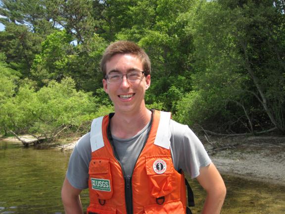 A man in an orange vest