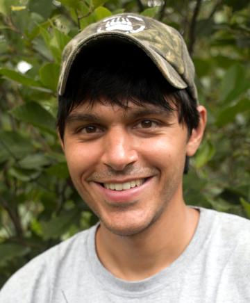 Alex Kumar weearing a camouflage baseball hat