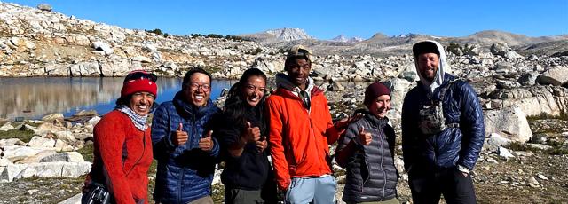 A group of people standing in front of rocks