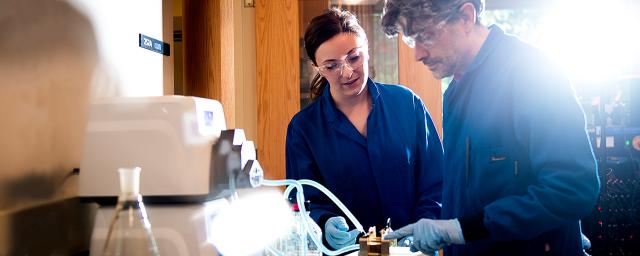 A female student and a professor research battery technology